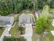 Aerial view of a home with lush landscaping, a well-manicured lawn, and a long driveway for ample parking at 3914 Old Chapel Hill Rd, Durham, NC 27707