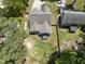 A bird's eye view of a home, detached garage, and a spacious, fenced-in backyard with a relaxing hot tub at 3914 Old Chapel Hill Rd, Durham, NC 27707