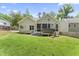 Back exterior featuring a screen porch and hot tub, with grassy areas at 3914 Old Chapel Hill Rd, Durham, NC 27707
