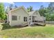 Back exterior featuring a screen porch and hot tub, with grassy areas at 3914 Old Chapel Hill Rd, Durham, NC 27707