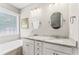 Well-lit bathroom features dual sinks, granite countertops, and a soaking tub at 3914 Old Chapel Hill Rd, Durham, NC 27707
