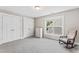 Comfortable bedroom features carpeted floors, a rocking chair, and ample closet space at 3914 Old Chapel Hill Rd, Durham, NC 27707