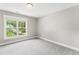 Bright bedroom featuring a large window with natural light and neutral paint at 3914 Old Chapel Hill Rd, Durham, NC 27707