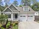 Charming home featuring a two-car garage, lush landscaping, and inviting front porch at 3914 Old Chapel Hill Rd, Durham, NC 27707