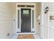 Welcoming front entrance featuring a black door with sidelights and modern hardware at 3914 Old Chapel Hill Rd, Durham, NC 27707
