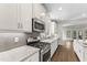Well-lit kitchen boasts stainless steel appliances, mosaic backsplash, and white cabinetry at 3914 Old Chapel Hill Rd, Durham, NC 27707