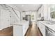 Open kitchen with a center island, white cabinetry, and hardwood floors, perfect for entertaining at 3914 Old Chapel Hill Rd, Durham, NC 27707