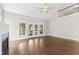 Bright and airy living room with fireplace, ceiling fan, and French doors leading to outdoor space at 3914 Old Chapel Hill Rd, Durham, NC 27707
