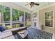 Relaxing screened porch with comfortable seating, patterned rug, and views of the backyard at 3914 Old Chapel Hill Rd, Durham, NC 27707
