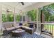 Cozy screened porch with ceiling fans, stylish outdoor furniture, and a view of the lush greenery at 3914 Old Chapel Hill Rd, Durham, NC 27707