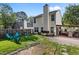 Large fenced backyard with covered patio area, seating, and ample green space at 4216 Lake Woodard Dr, Raleigh, NC 27604