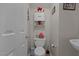 Well-lit half bathroom featuring a toilet and sink with decor and a white door at 4216 Lake Woodard Dr, Raleigh, NC 27604