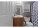 Bathroom featuring a vanity, toilet, mirror, updated shower curtain, and storage cabinet at 4216 Lake Woodard Dr, Raleigh, NC 27604