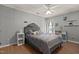 Cozy bedroom featuring wood floors, a comfortable bed, and natural light from the windows at 4216 Lake Woodard Dr, Raleigh, NC 27604