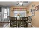 Cozy dining area with seating for four, a ceiling fan, and plenty of natural light at 4216 Lake Woodard Dr, Raleigh, NC 27604
