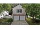 Charming two-story home featuring a two-car garage, brick accents, and well-manicured landscaping at 4216 Lake Woodard Dr, Raleigh, NC 27604