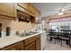Cozy kitchen featuring wooden cabinets, white appliances, and a breakfast table with seating at 4216 Lake Woodard Dr, Raleigh, NC 27604