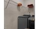 Bright laundry room with modern washer and dryer, and wire shelving for storage at 4216 Lake Woodard Dr, Raleigh, NC 27604