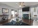 Living room features a fireplace, hardwood floors, ceiling fan, and glass doors to the patio at 4216 Lake Woodard Dr, Raleigh, NC 27604