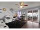Comfortable living room featuring a ceiling fan, plush seating, hardwood floors, and glass doors to the patio at 4216 Lake Woodard Dr, Raleigh, NC 27604