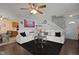 Comfortable living room featuring a ceiling fan, plush seating, and hardwood floors at 4216 Lake Woodard Dr, Raleigh, NC 27604