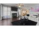 Cozy living room with a fireplace, plush seating, ceiling fan, and hardwood floors at 4216 Lake Woodard Dr, Raleigh, NC 27604