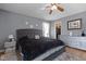 Spacious bedroom featuring a queen-sized bed, ceiling fan, closet and grey decor at 4216 Lake Woodard Dr, Raleigh, NC 27604