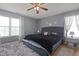 Calming bedroom featuring a queen-sized bed, ceiling fan, and grey colored walls and decor at 4216 Lake Woodard Dr, Raleigh, NC 27604