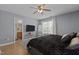 Spacious bedroom featuring a queen-sized bed, ceiling fan, closet and television on the wall at 4216 Lake Woodard Dr, Raleigh, NC 27604