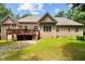 The backyard features a wood deck with outdoor furniture and a well-maintained lawn surrounded by mature trees at 4306 Infinity Ln, Durham, NC 27705