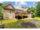 Backyard featuring a wooden deck, well-manicured lawn, and stone walkway enhancing the outdoor living space at 4306 Infinity Ln, Durham, NC 27705