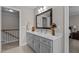 Bathroom featuring a vanity with dual sinks and a staircase access at 4306 Infinity Ln, Durham, NC 27705
