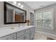 Bright bathroom with a large mirror, a window, and ample lighting at 4306 Infinity Ln, Durham, NC 27705