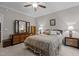 Inviting bedroom featuring plush bedding, a ceiling fan, and ample natural light at 4306 Infinity Ln, Durham, NC 27705