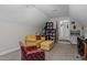 Spacious bonus room with varied seating, storage shelves, and a view into a hallway at 4306 Infinity Ln, Durham, NC 27705
