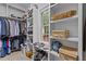 Walk-in closet with built-in shelves, hanging racks, and a window for natural light at 4306 Infinity Ln, Durham, NC 27705