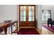 Grand entryway featuring hardwood floors, a decorative rug, and wood double doors with glass panels at 4306 Infinity Ln, Durham, NC 27705