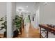 Hallway with hardwood floors, staircase, large plant and view to living room at 4306 Infinity Ln, Durham, NC 27705