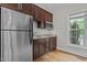 Modern kitchen features stainless steel appliances, wood cabinets, and a window at 4306 Infinity Ln, Durham, NC 27705