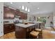 Modern kitchen features an island with seating, pendant lights, and stainless steel appliances at 4306 Infinity Ln, Durham, NC 27705