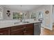 A kitchen with granite counters, stainless steel appliances, and access to the deck seen through the glass doors at 4306 Infinity Ln, Durham, NC 27705