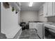 Well-equipped laundry room with white cabinetry, modern appliances, and tiled flooring at 4306 Infinity Ln, Durham, NC 27705