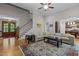 Open living room showcases hardwood floors, a staircase, and a spacious seating area with a large rug at 4306 Infinity Ln, Durham, NC 27705