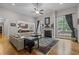 Spacious living room featuring hardwood floors, a fireplace, and large windows for natural light at 4306 Infinity Ln, Durham, NC 27705
