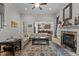 Living room features hardwood floors, a fireplace, and open layout to kitchen at 4306 Infinity Ln, Durham, NC 27705
