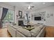 Comfortable living room with fireplace, large windows, hardwood floors, and built in shelving at 4306 Infinity Ln, Durham, NC 27705