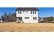 View of a home's exterior showing the expansive backyard with room for landscaping at 448 Golden Dragonfly St, Wake Forest, NC 27587