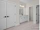 Bathroom featuring double closets, a neutral vanity, and a door to a toilet room at 448 Golden Dragonfly St, Wake Forest, NC 27587