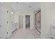 Bright bathroom with double sinks, marble-look tile floor, glass enclosed shower, and a doorway to another room at 448 Golden Dragonfly St, Wake Forest, NC 27587