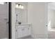 Modern bathroom showcasing a single vanity, large mirror, stylish lighting and a tile shower with a black frame at 448 Golden Dragonfly St, Wake Forest, NC 27587